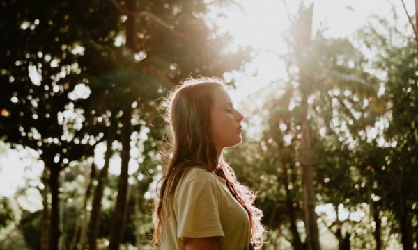 woman standing eyes closed