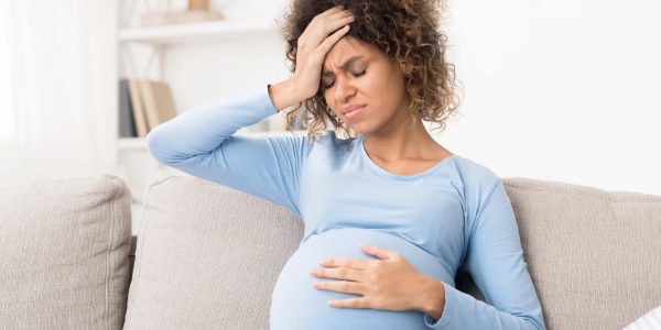woman pregnant with headache