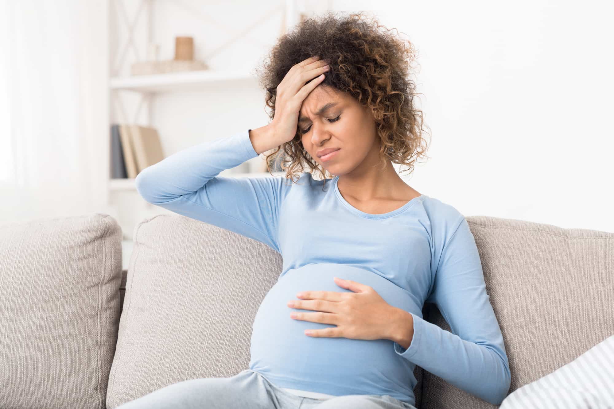 woman pregnant with headache