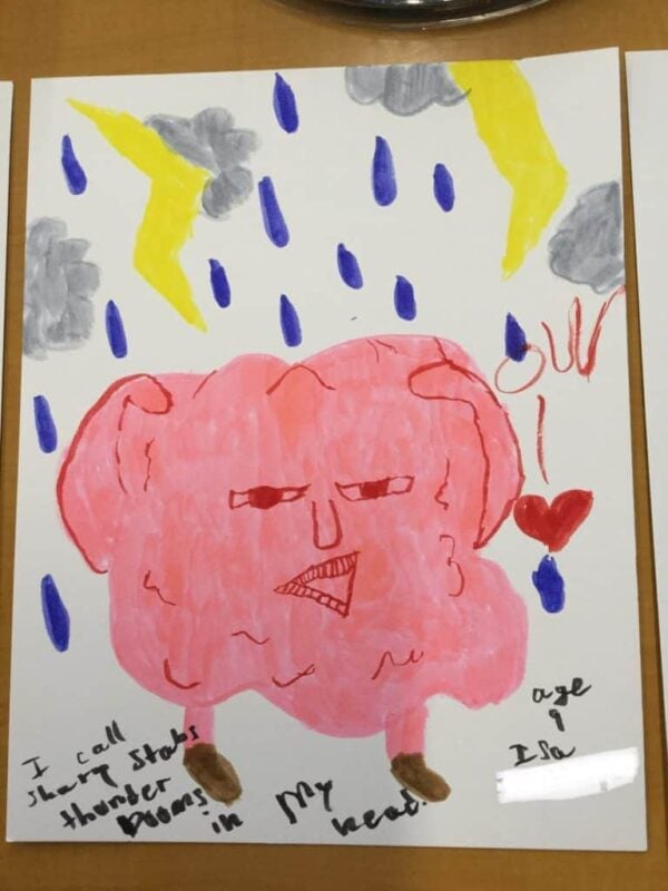 A pink brain with a face stands under rain and lightning, with a red heart nearby. Text reads: “I call sharp static thunder booms in my head! Age 9, Isy.”.