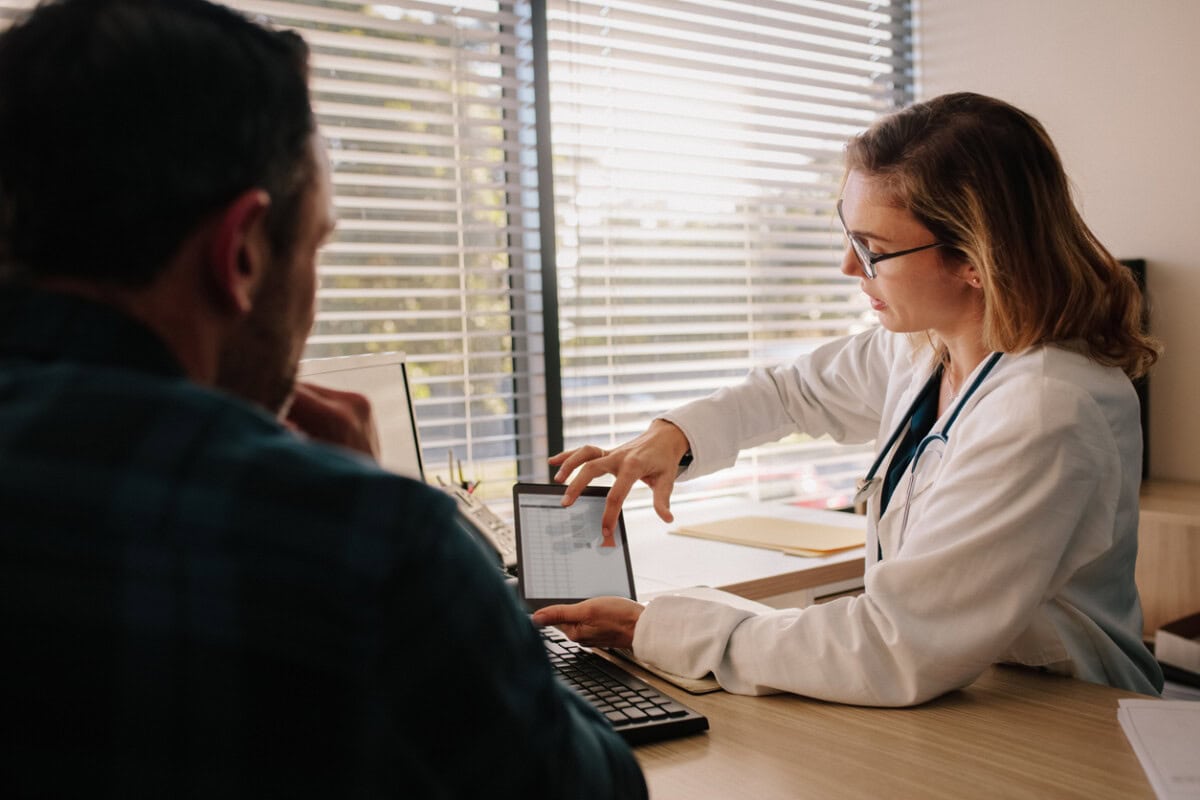 doctor showing test results on tablet to her patient