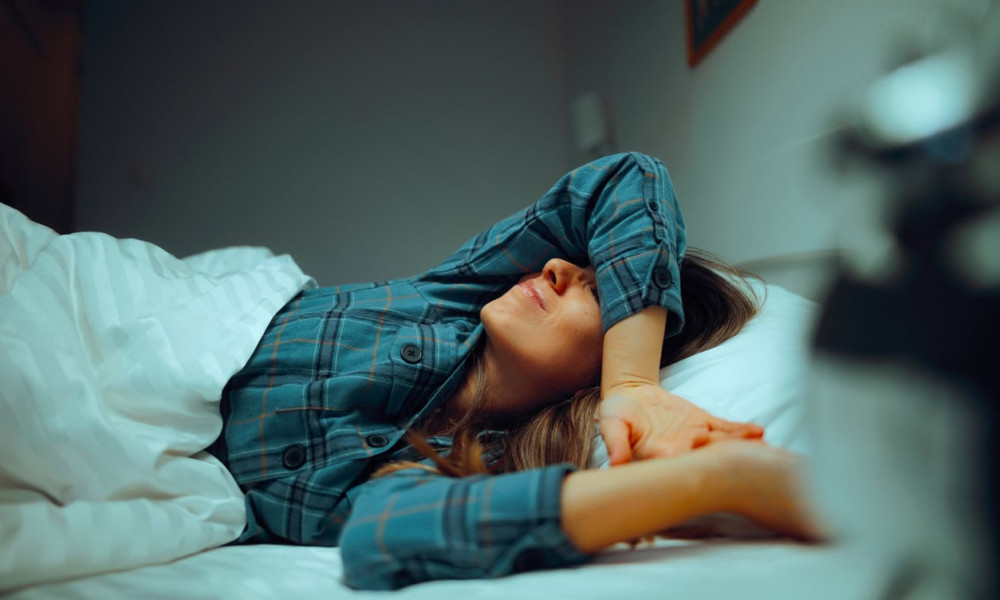 tired woman trying to seep suffering from insomnia