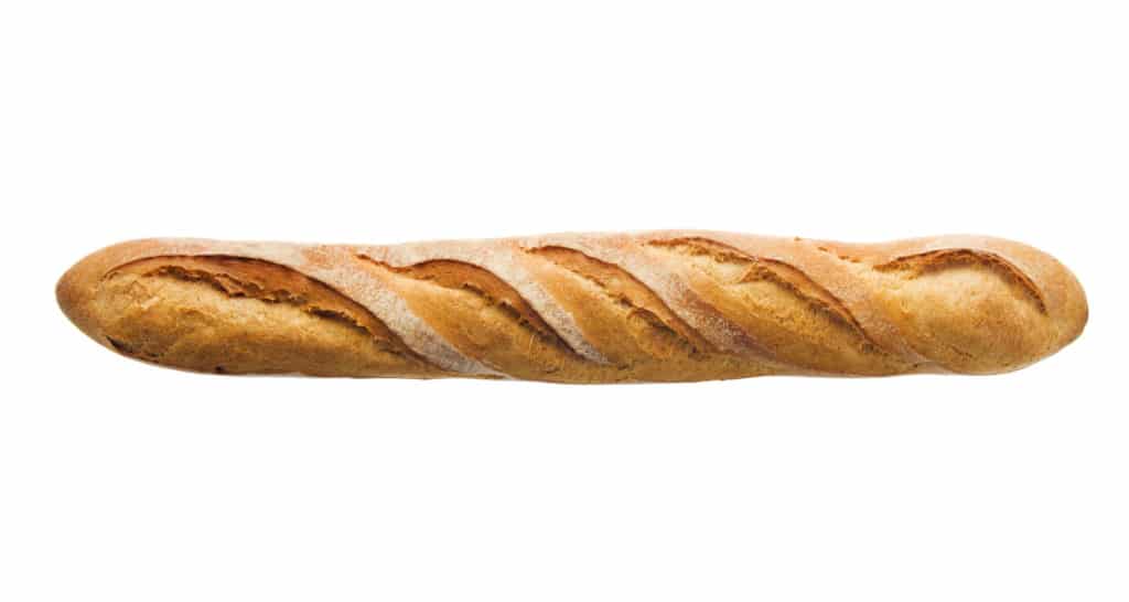 A single, whole French baguette with a golden-brown crust and diagonal slashes, isolated on a white background.