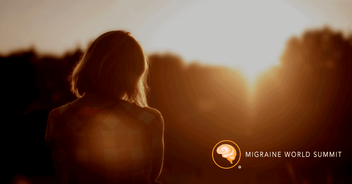 A person stands outdoors at sunset, facing away from the camera. The Migraine World Summit logo appears in the lower right corner.