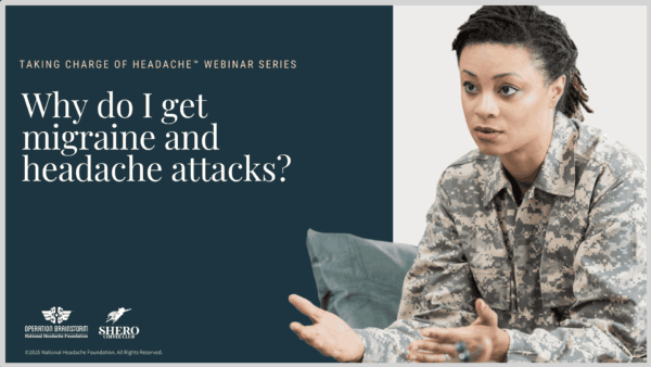 A woman in military uniform speaks while seated next to a blue screen displaying, 
